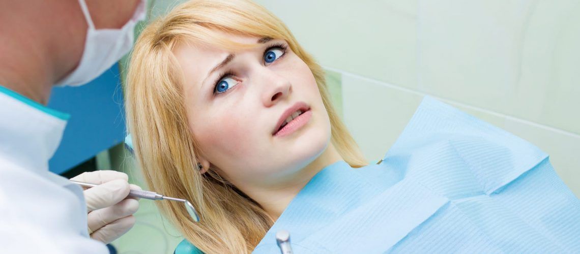 Woman looking afraid of dentist