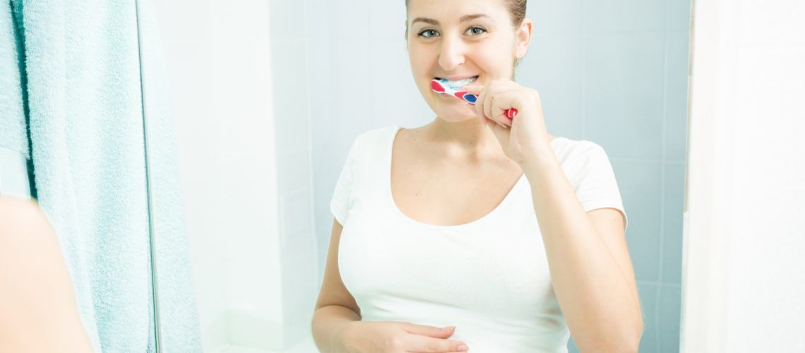 Pregnant Woman Caring For Her Teeth