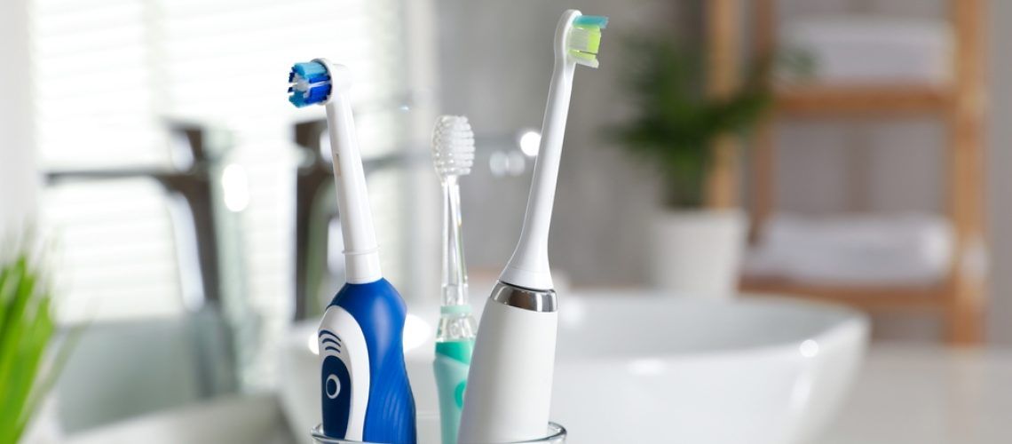 Electric,Toothbrushes,In,Glass,Holder,Indoors,,Closeup