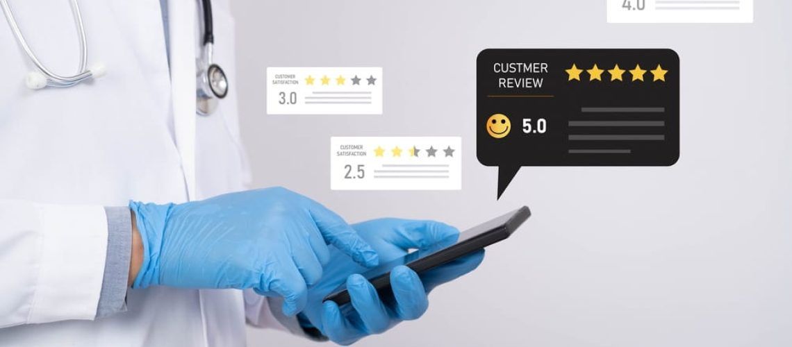 Doctor using smartphone with customer review rating interface, highlighting patient satisfaction and online feedback.